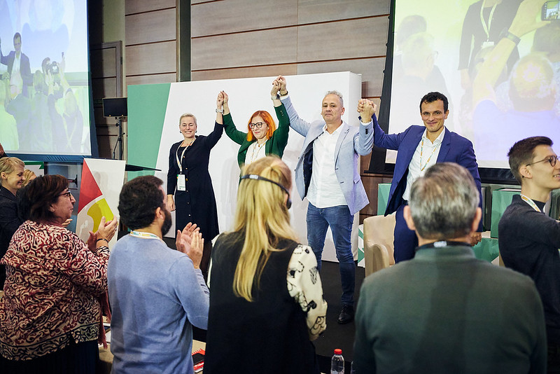 New EFFAT leadership standing and holding hand raised in celebration.