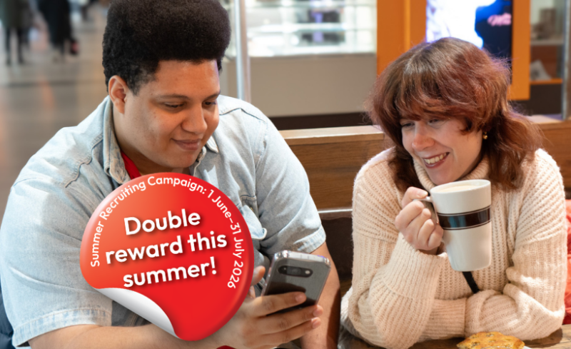 Two smiling people sit at a café table, one holding a mug while both look at a smartphone, with a red promotional badge reading "Double reward this summer! Summer Recruiting Campaign 1 June–31 Aug 2024."